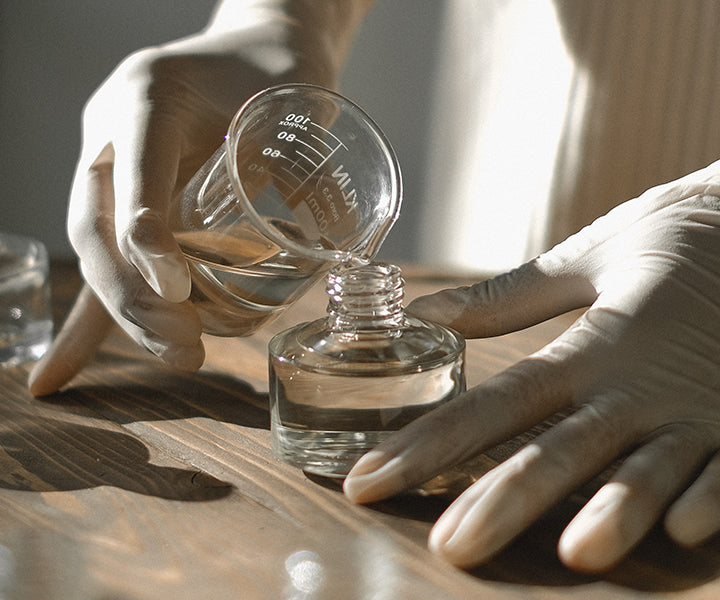Alchemist Pouring Oil Into Diffuser Glass Jar