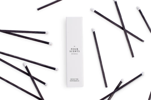 Four Scents White Match Box Surrounded by Luxury Long Black Matches With White Tip